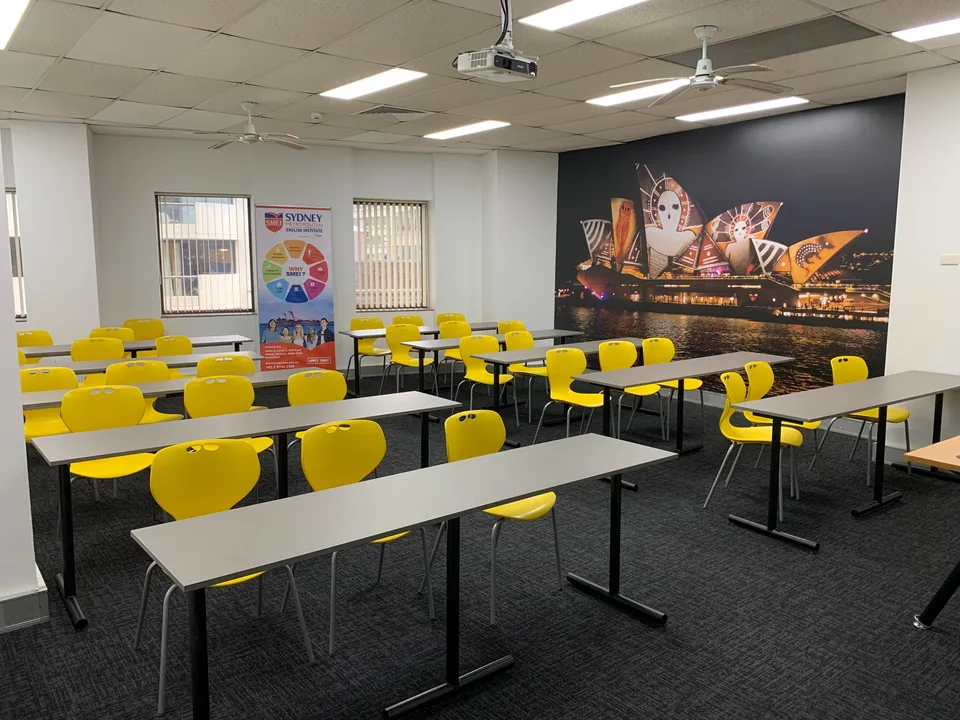 SMIC classroom with yellow chairs, desks and a Sydney Harbour wall mural