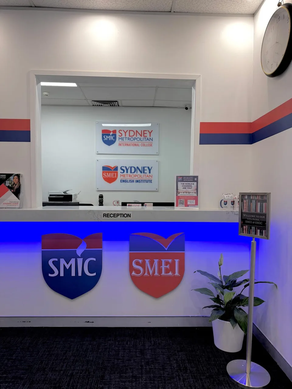 SMIC and SMEI reception desk with college signs and blue lighting
